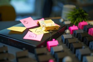 Miniature houses and sticky notes with house drawings.